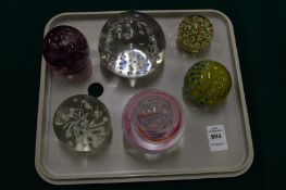 Six glass paperweights.