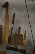A large wooden butter knife, three wooden spoons and an old dairy brush.