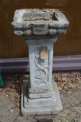 A large reconstituted stone bird bath.