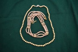 Two pearl necklaces.