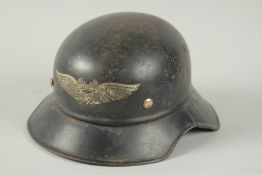 A GERMAN LUSTSCHUTZ HELMET with badge.