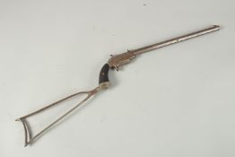 A 19TH CENTURY RIMFIRE POSTOL with stock. 74cm long.
