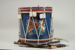 A ROYAL HIGHLANDERS REGIMENTAL DRUM WITH STICKS AND BELT.