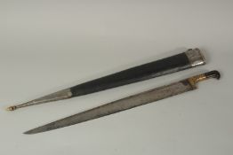 AN EARLY TURKISH HUNTING SWORD in a leather scabbard.