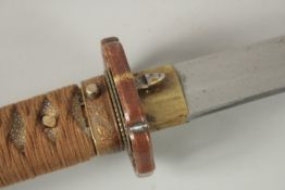 A JAPANESE KATANI OFFICER'S SWORD with shagreen handle and leather scabbard, WWII. 93cm long.