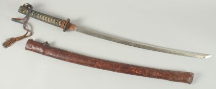 A JAPANESE SWORD with shagreen leather bound handle, tsuba and leather sheath, curving blade 74cm,