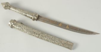 AN INDIAN SHORT SWORD with engraved black and silver handle and sheath. 52cm long.