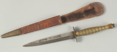 A FAIRBAIRN-SYKES TYPE COMMANDO KNIFE in a leather sheath and wire handle. 32cm long.