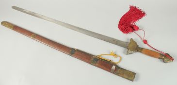 A SWORD with wooden handle and metal sheath.