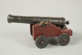 A MINIATURE MODEL OF A CANNON. 23cm long