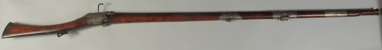 A 17TH CENTURY TURKISH OTTOMAN MATCHLOCK CASTLE RIFLE, with heavy ribbed barrel and silver bands and