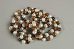 A LONG STRING OF PEARL AND MALACHITE BEADS. 120cm long.