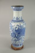 A CHINESE BLUE AND WHITE PORCELAIN FLOOR STANDING VASE on a hardwood stand, decorated with panels of