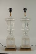 A GOOD PAIR OF CUT GLASS AND METAL URN SHAPED LAMPS on square marble bases. 60cm high.