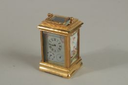 A BRASSS THREE PIECE MINIATURE CARRIAGE CLOCK with painted panels and carrying handle. 8cm high.