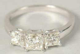 AN 18CT WHITE GOLD GRADUATED PRINCESS CUT DIAMOND 3 STONE RING, with certificate. Diamond 1.51ct.