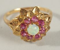 A RUBY AND OPAL GOLD RING.