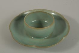 A CHINESE RU WARE PORCELAIN TEA CUP with petal form rin. 19cm wide overall.