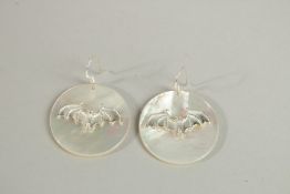 A PAIR OF SILVER AND MOTHER OF PEARL BAT EARRINGS.