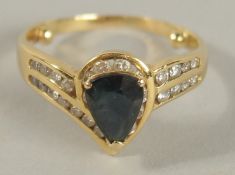 AN 18CT GOLD TEAR DROP SAPPHIRE AND DIAMOND RING.
