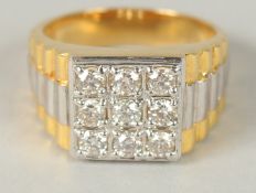 A 9CT YELLOW AND WHITE GOLD 9 STONE DIAMOND PANEL RING with watch bracelet style shank. RBC