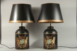 A PAIR OF BLACK TOLEWARE CANNISTERS converted to lamps with shades.
