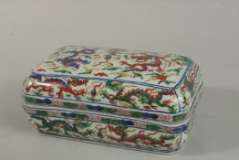 A CHINESE DOUCAI PORCELAIN RECTANGULAR BOX AND COVER with dragons and pheonix. 24cm x 14cm.