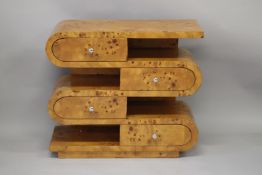 AN ART DECO DESIGN BLOND WOOD SIDE UNIT with an arrangement of four drawers with curved ends and