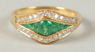 AN EMERALD AND DIAMOND HALF HOOP RING, 18CT YELLOW GOLD.