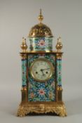 A LARGE LOUIS XVITH STYLE BRASS ENAMEL CLOCK with domed top, column sides and ornate brass base.