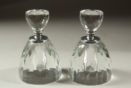 A PAIR OF CUT GLASS CIRCULAR PERFUME BOTTLES AND STOPPERS. 13cms high