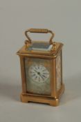 A MINIATURE BRASS CARRIAGE CLOCK with painted panels and carrying handle. 6cm high.