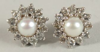 A PAIR OF WHITE GOLD, PEAR AND DIAMOND CLUSTER STUDS.