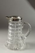 A SLICE CUT GLASS WATER JUG with silver band. Birmingham.