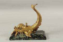 A GOOD GILT BRONZE DOLPHIN on a rectangular marble base. 25cms long x 24cms high.