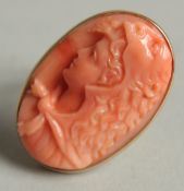 A CARVED CORAL CAMEO RING.