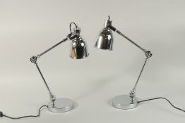 A SMALL PAIR OF CHROME ANGLE POISE LAMPS.