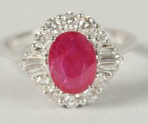AN 18CT WHITE GOLD OVAL RUBY, RBC AND BAGUETTE DIAMOND CLUSTER RING. Ruby 1.26ct. Diamonds 0.5ct.