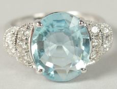 AN 18CT WHITE GOLD RING SET WITH AN OVAL AQUAMARINE FLANKED BY RBC DIAMONDS. Aquamarine 4.55ct.