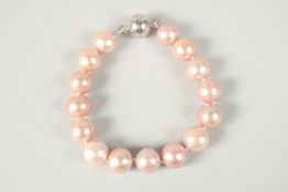 AN 11mm NATURAL PINK FRESHWATER PEARL BRACELET.