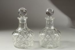 A PAIR OF BULBOUS SLICE CUT DECANTER and stopper.