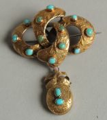 A 15CT GOLD TURQUOISE BEAD INSET BROOCH.