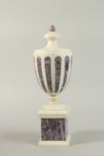 A GOOD ADAM DESIGN WHITE MARBLE URNLETTE with coloured marble ?? and pedestal base. 38cm high.