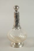 A SILVER MOUNTED WRYTHEN FLUTED DECANTER AND STOPPER. 28cm high.