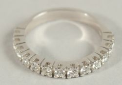 AN 18CT WHITE GOLD, 0.65CT DIAMOND HALF ETERNITY RING.