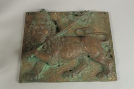 A 19TH CENTURY RELIEF CAST BRONZE PLAQUE depicting a lion passant, wearing a crown, holding a pole