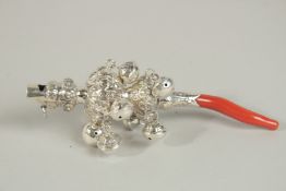 A SILVER AND CORAL RATTLE.
