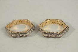 A GOOD PAIR OF GOLD BANGLES inset with diamonds.