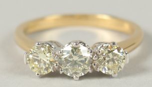 A CERTIFIED 18CT WHITE AND YELLOW GOLD DIAMOND TRILOGY RING. Diamonds 1.26ct. with certificate.