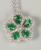 AN EMERALD AND DIAMOND WHITE GOLD PENDANT AND CHAIN.